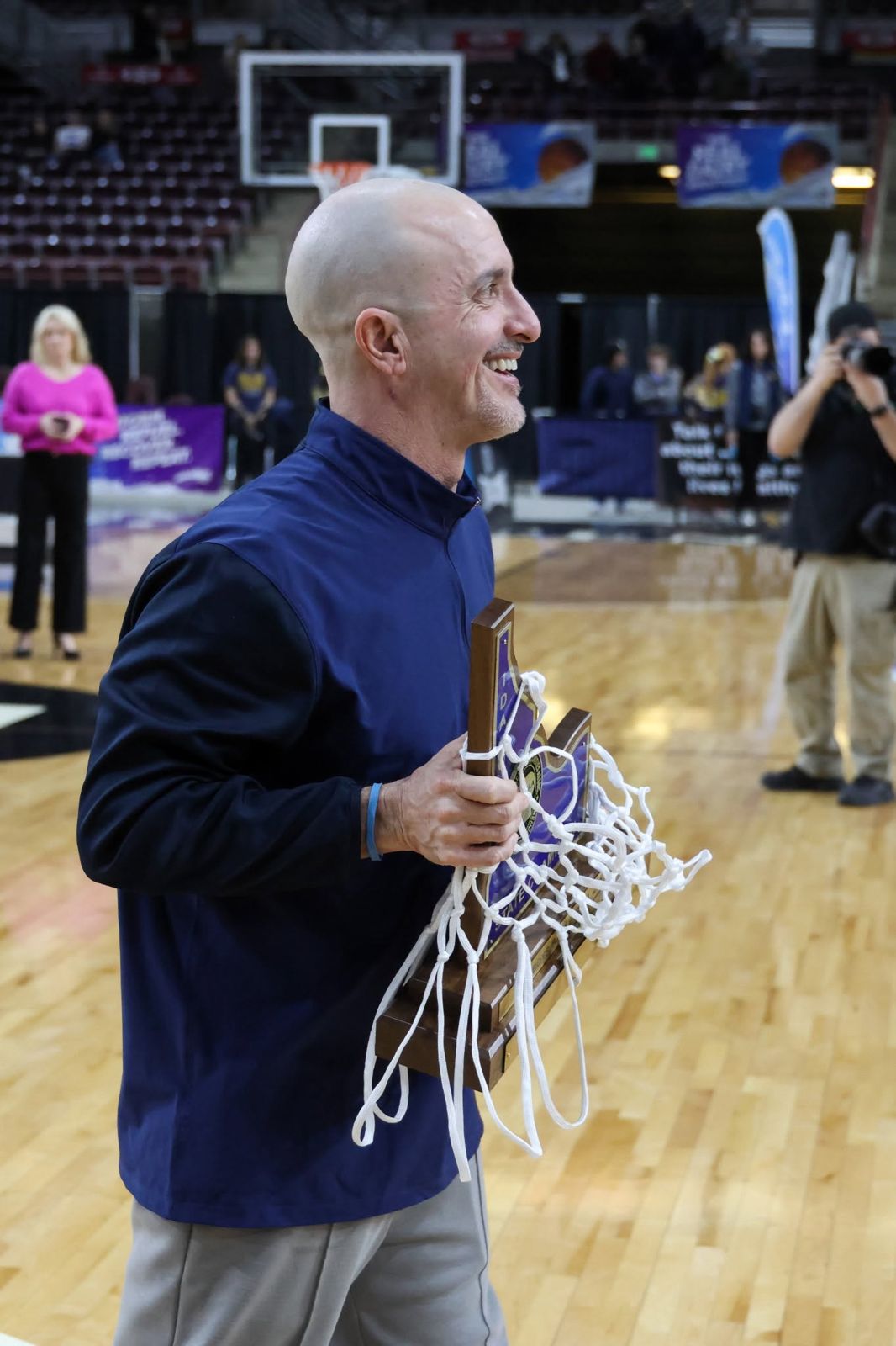 Coach Kelly Reed holding the 2023 Idaho 5A state championship trophy and net